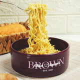 a bowl of noodles being lifted with a fork