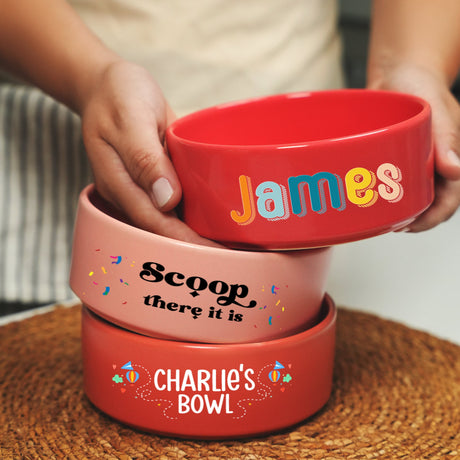 a person holding three bowls on top of a table