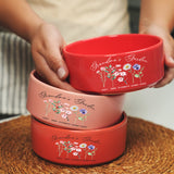 a person holding three bowls on top of a table