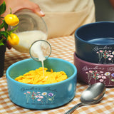 a person pouring milk into a bowl of cereal