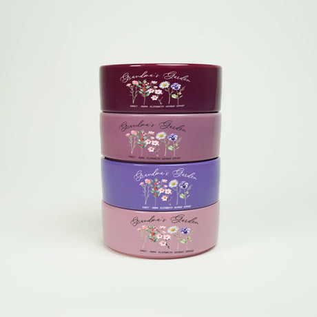 three tins with flowers on them are stacked on top of each other