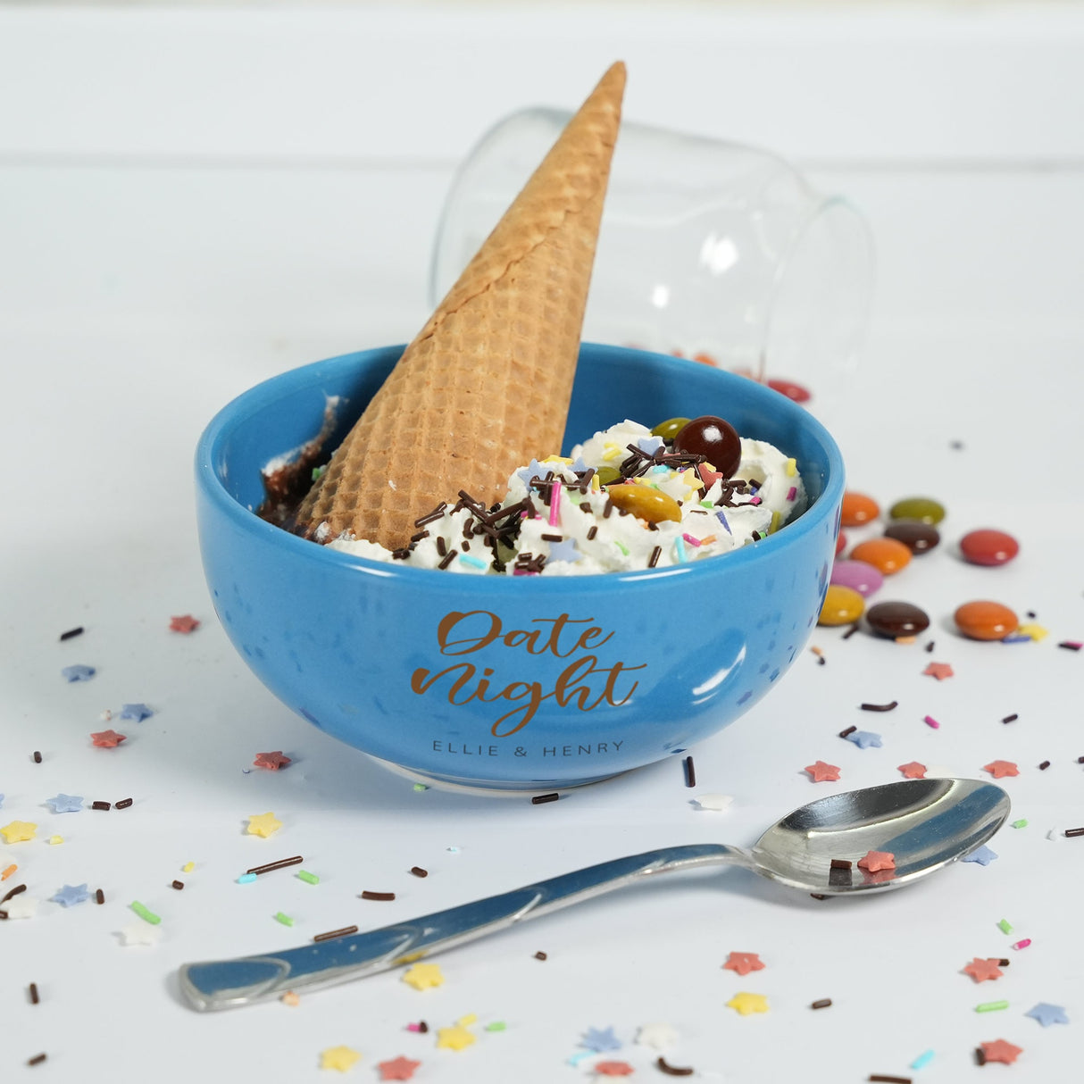 a bowl of ice cream with a spoon next to it