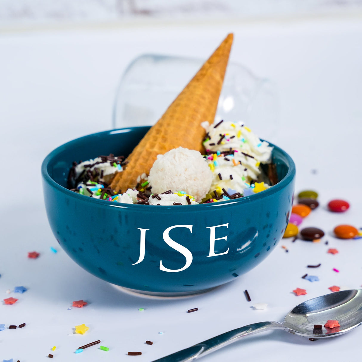 a blue bowl filled with ice cream and sprinkles