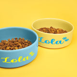 two bowls of dog food on a yellow background