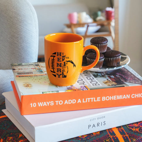 a stack of books sitting on top of a table next to a cup of coffee