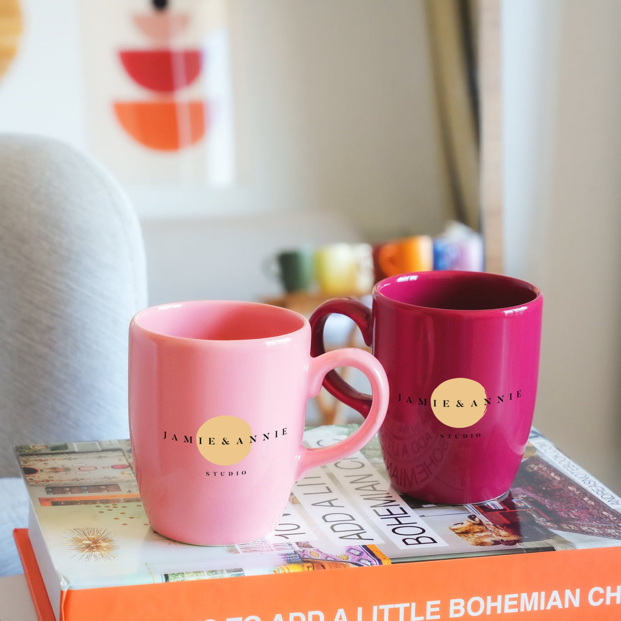 two coffee mugs sitting on top of a book