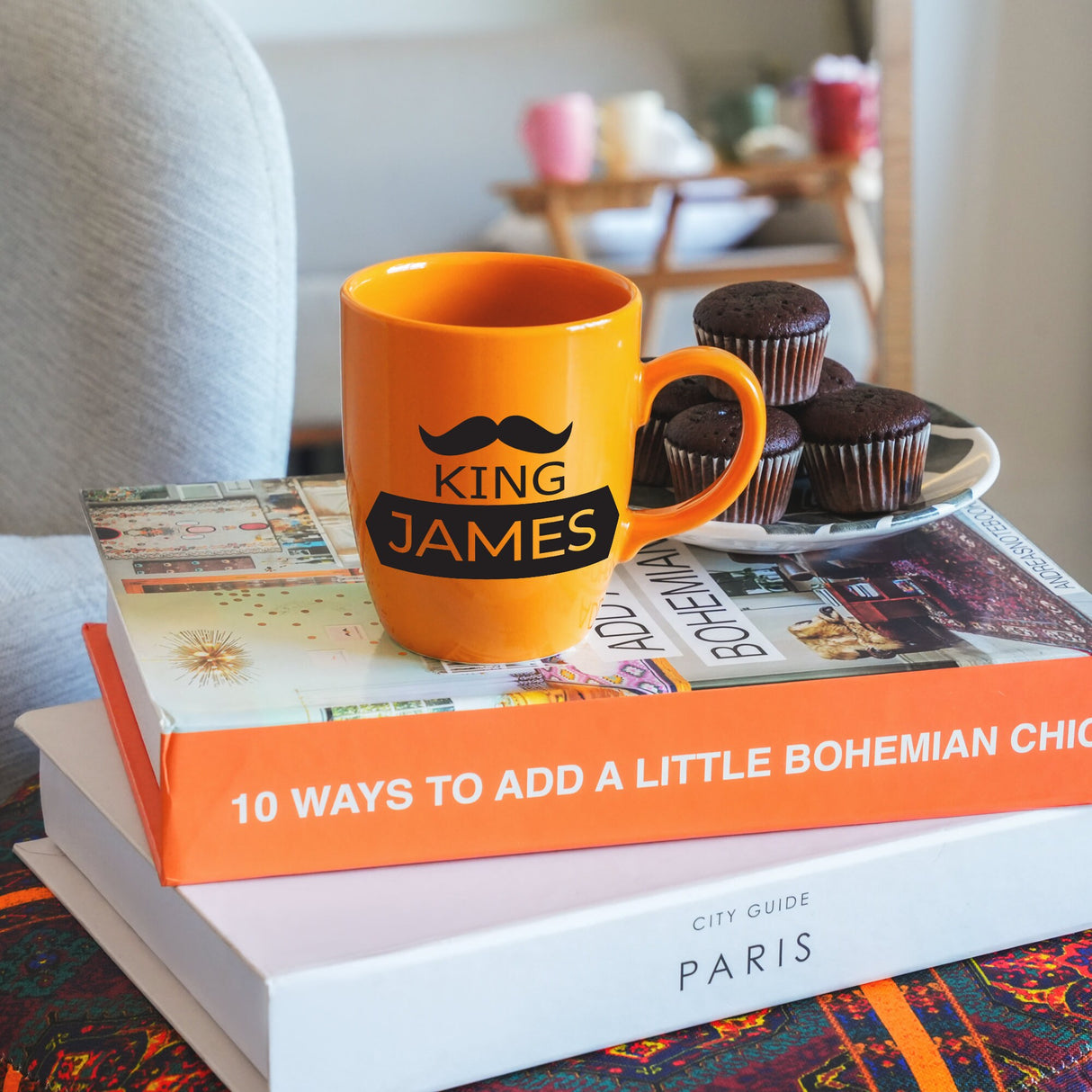 a stack of books sitting on top of a table next to a cup of coffee