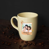 a coffee mug with a picture of two people on it