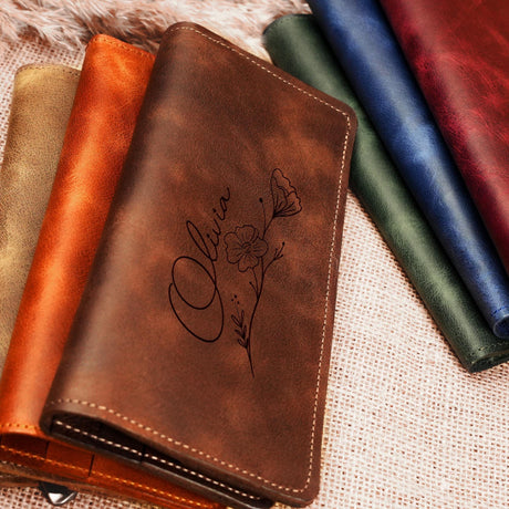 a leather wallet with a picture of a flower on it