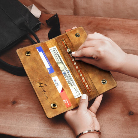 a woman is holding a wallet and a purse