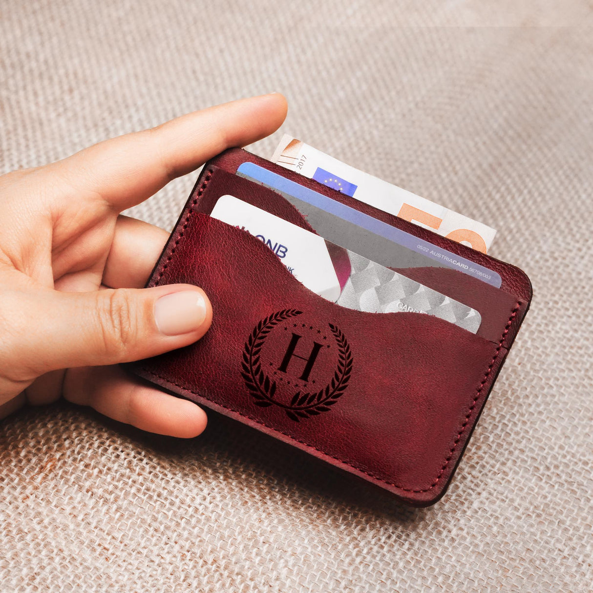 a person holding a wallet with a credit card in it