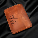 a leather wallet sitting on top of a black cloth