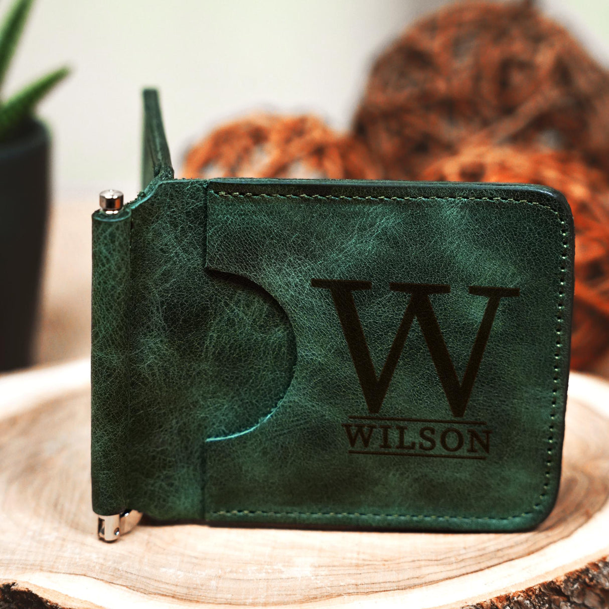 a personalized wallet sitting on top of a tree stump