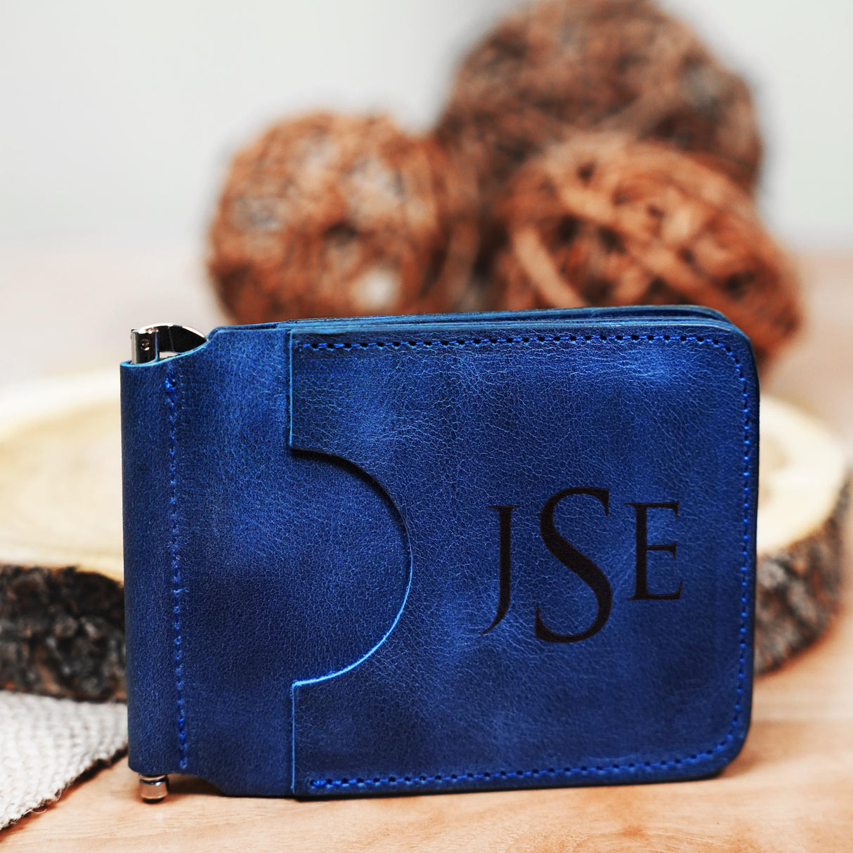 a blue wallet sitting on top of a wooden table