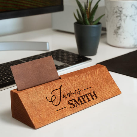 a wooden business card holder on a desk