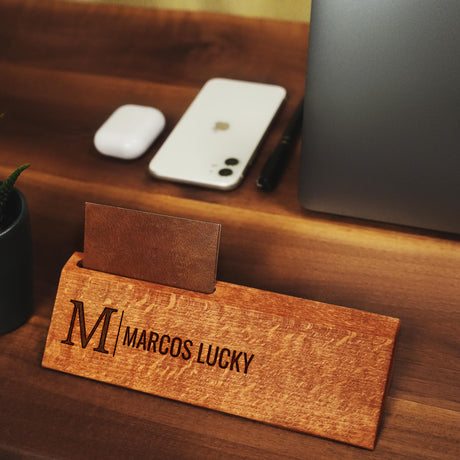 a wooden business card sitting on top of a wooden desk