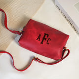 a red purse sitting on top of a white table