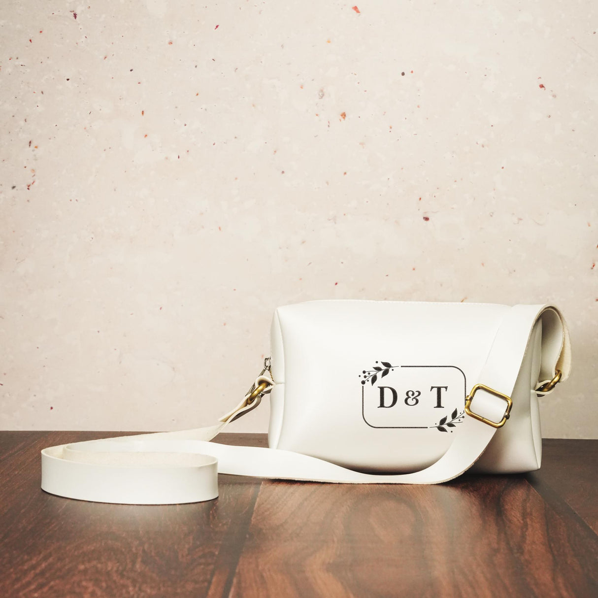 a white purse sitting on top of a wooden table