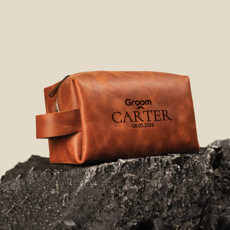 a brown leather bag sitting on top of a rock