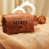 a brown leather bag with the name george written on it