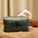 a personalized leather make - up bag with a monogrammed initial