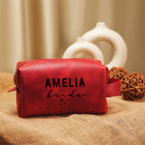 a red leather bag with a name on it