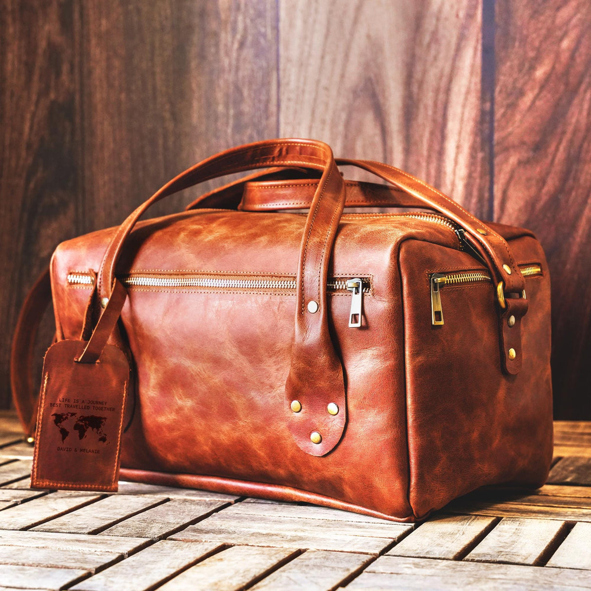 a brown leather bag sitting on top of a wooden table