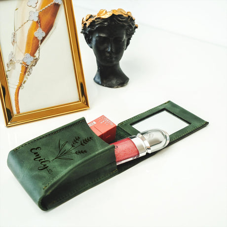 a picture frame and a green case with a red lipstick in it