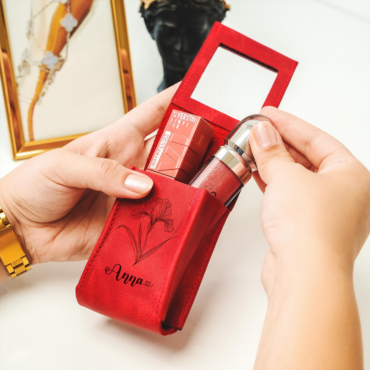 a person holding a red box with a lipstick in it