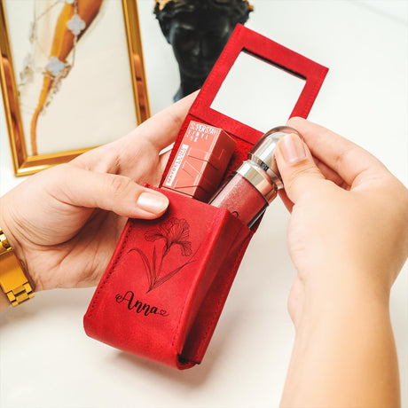 a person holding a red box with a lipstick in it