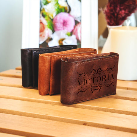 a couple of wallets sitting on top of a wooden table