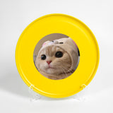 a yellow frisbee with a picture of a cat in it