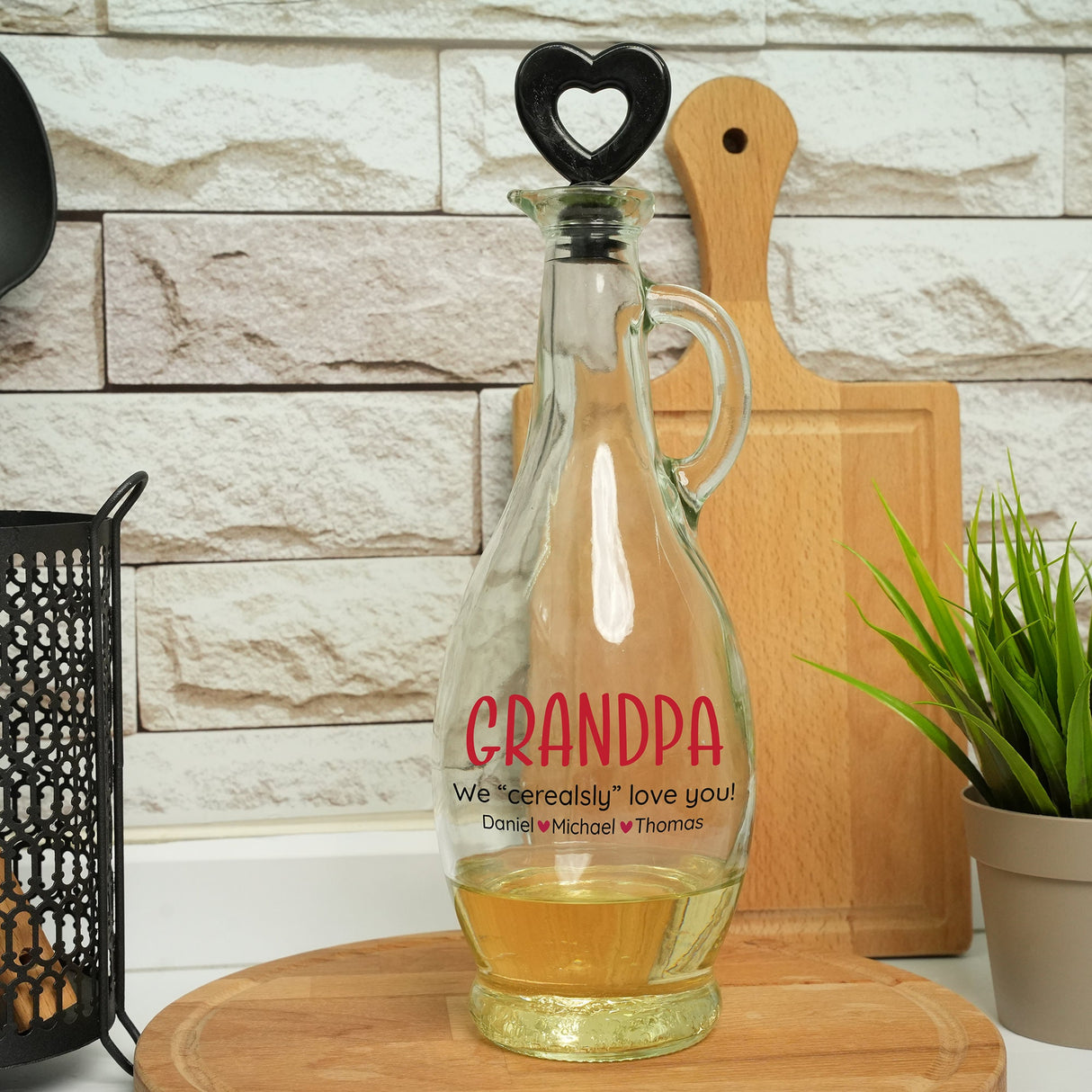 a glass carafe with a bottle of wine on a cutting board