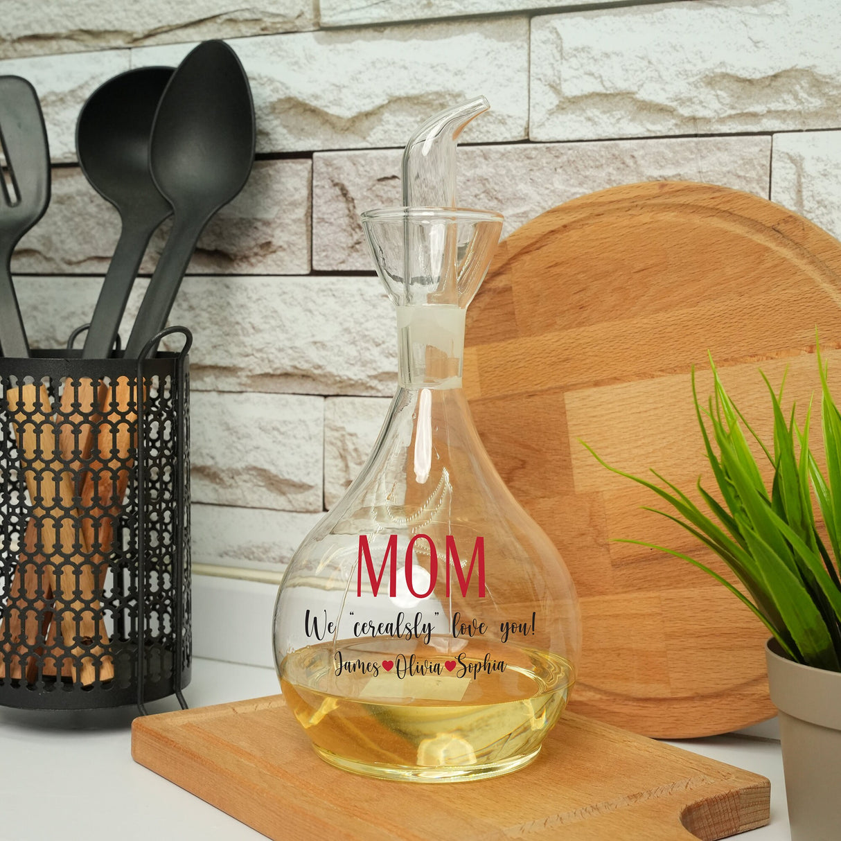 a glass bottle with a message on it sitting on a cutting board next to a