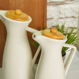 a couple of white vases sitting on top of a table