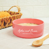 a bowl of soup next to a basket of bread