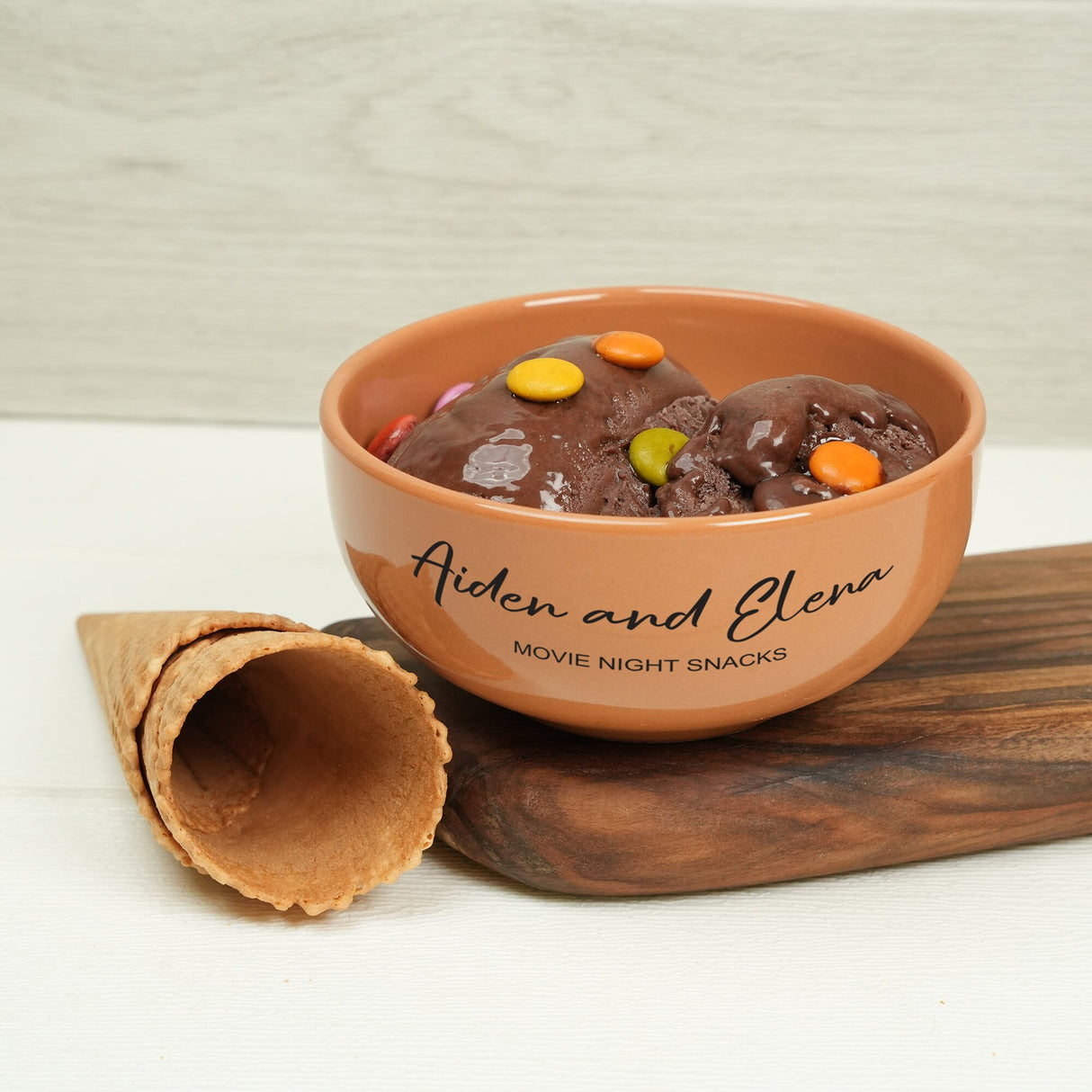 a bowl of food sitting on top of a wooden cutting board