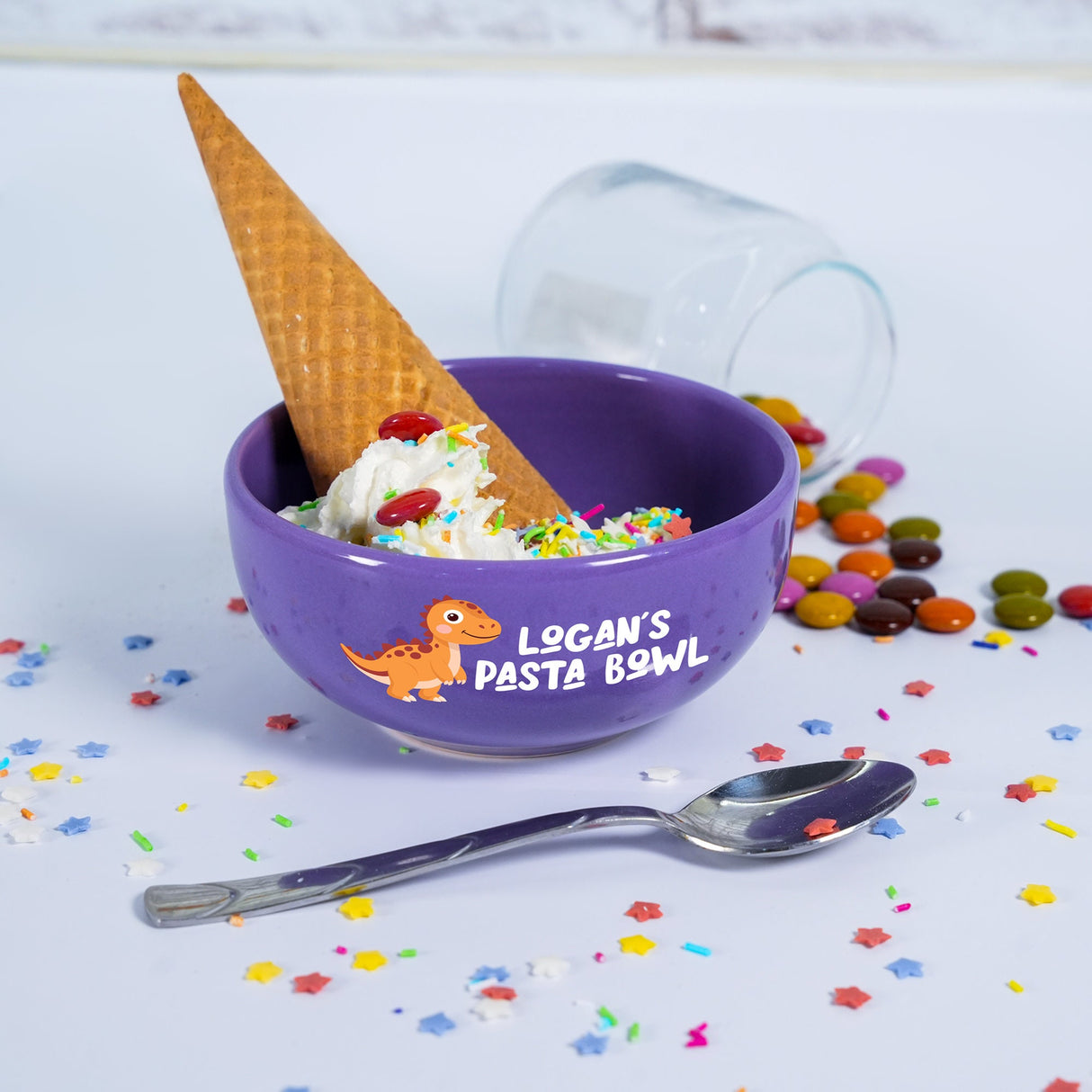 a purple bowl filled with ice cream and sprinkles