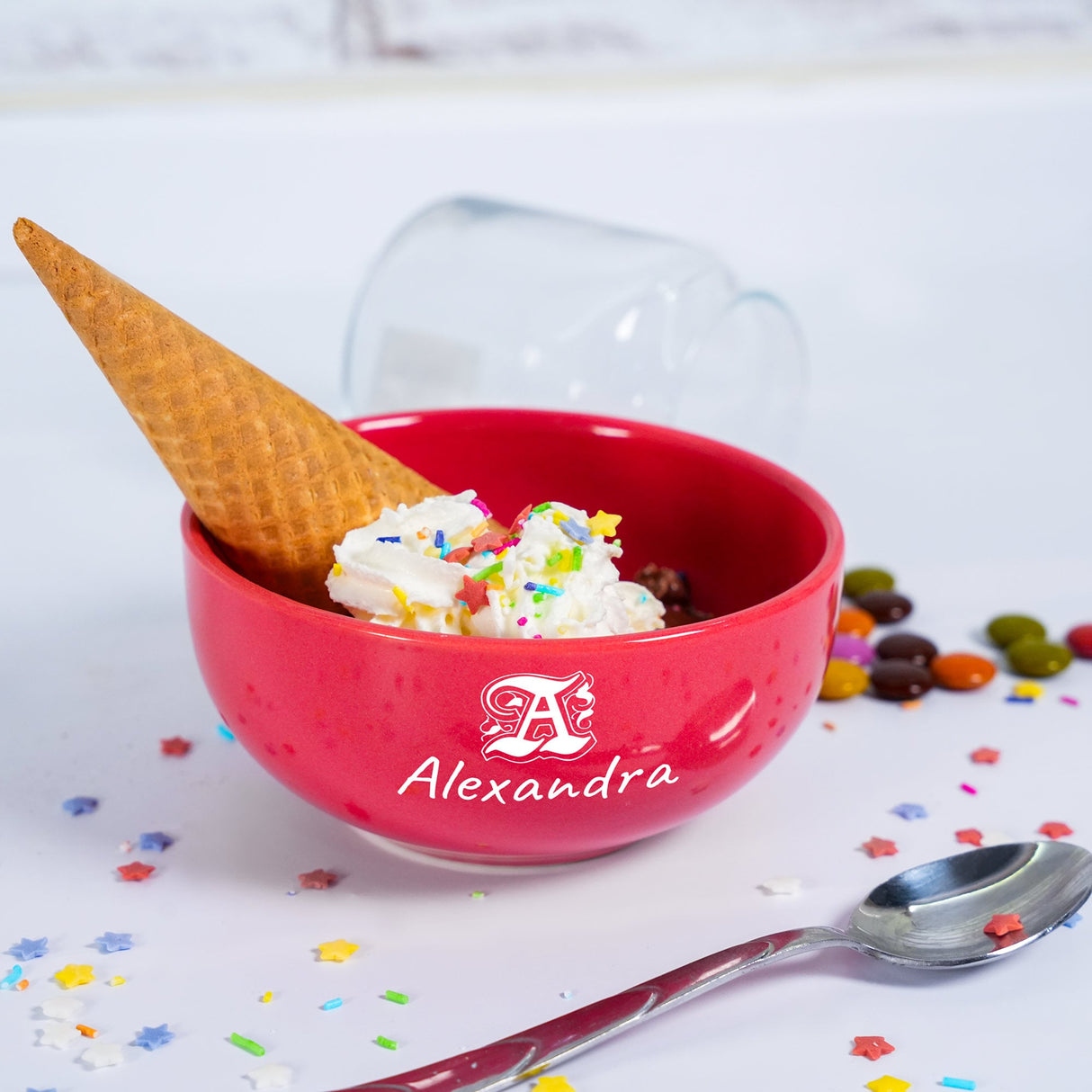 a red bowl filled with ice cream and sprinkles