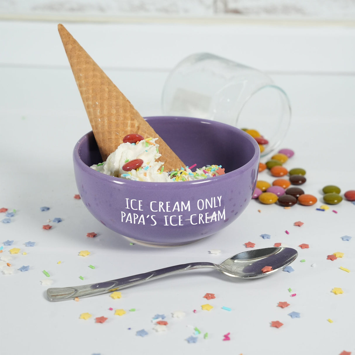 a bowl of ice cream with a spoon next to it