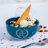 a blue bowl filled with ice cream and sprinkles