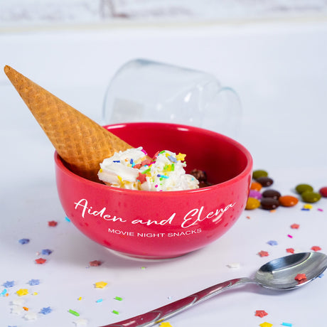 a red bowl filled with ice cream and sprinkles