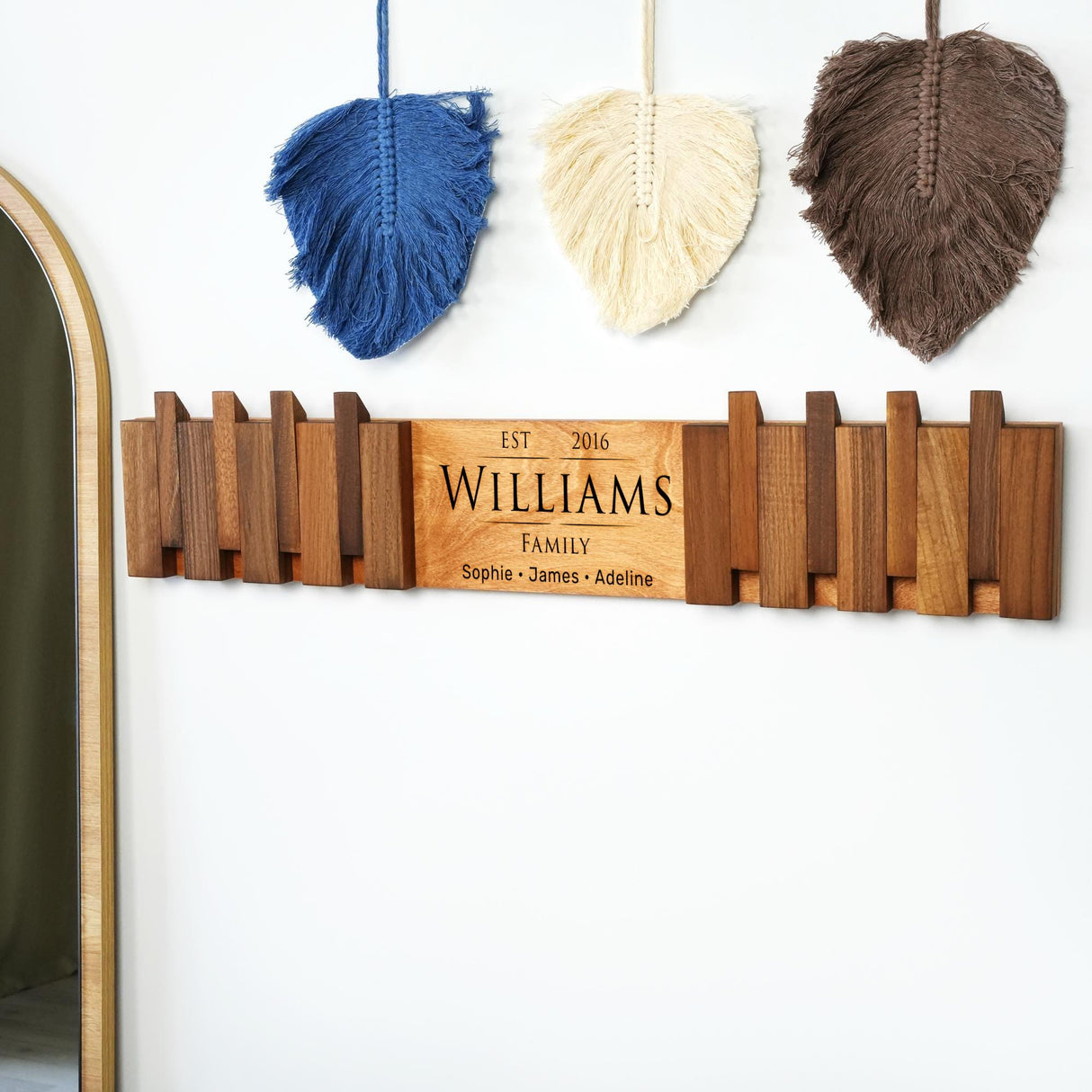 a wooden sign hanging on a wall next to a mirror