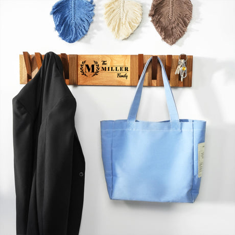 a blue bag hanging on a wall next to a coat rack