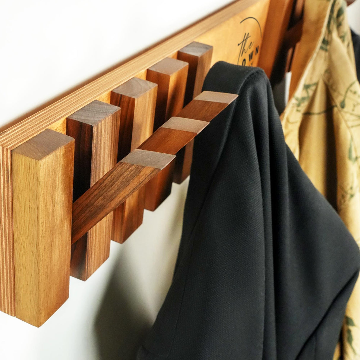 a coat rack with a coat hanging on it