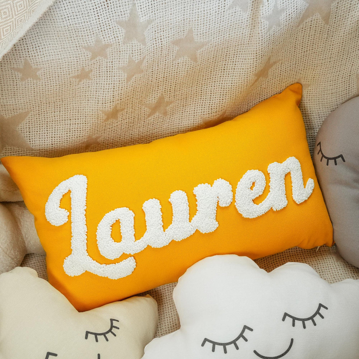 a yellow pillow with the word lauren on it