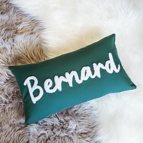 a green pillow with the word bernard written on it