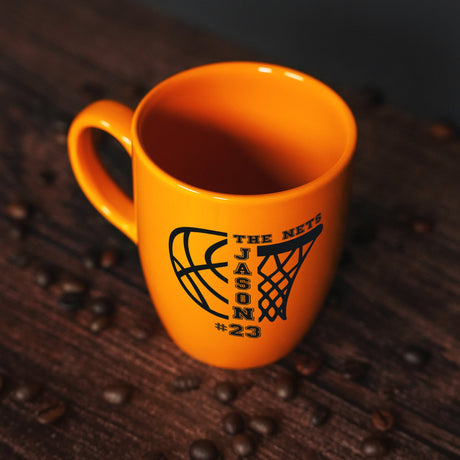 a yellow coffee cup sitting on top of a wooden table