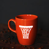 a red coffee mug with a basketball hoop on it