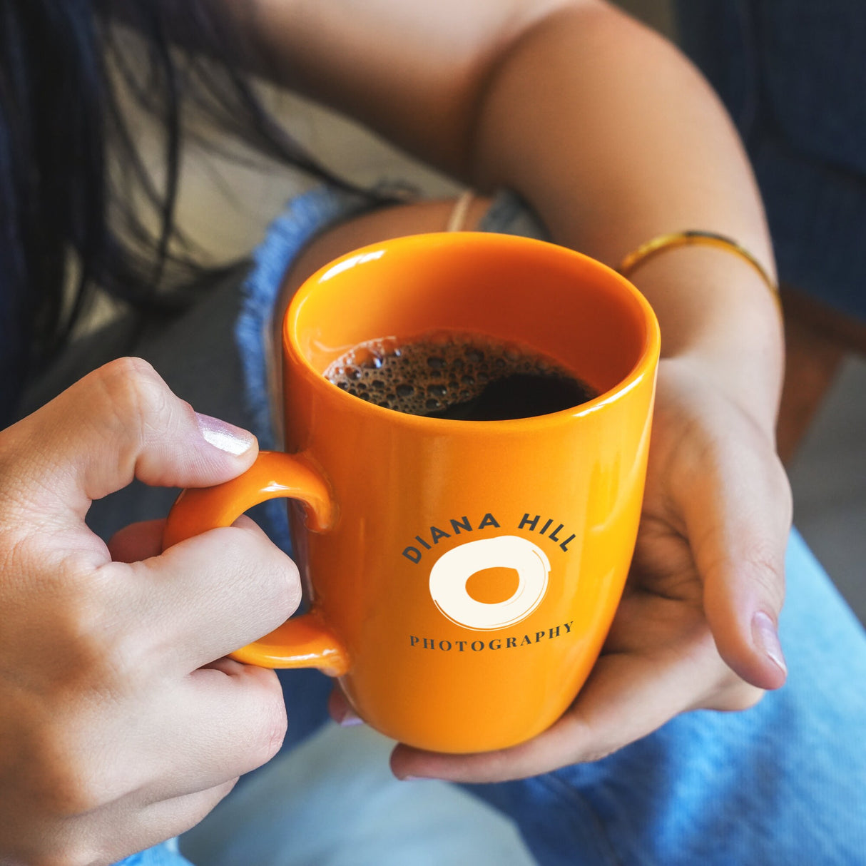 a person holding a cup of coffee in their hands